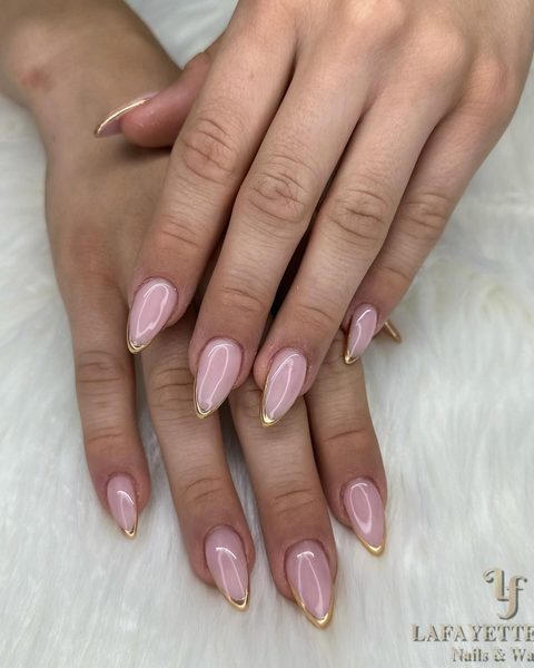 Nude almond nails with fine gold French tips, by Lafayette Nails