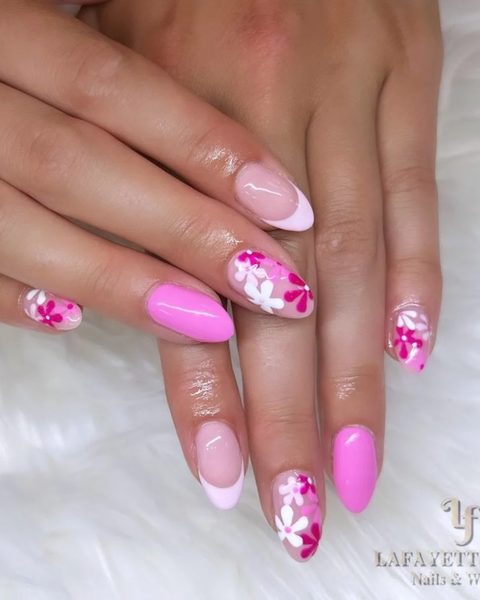 Pink French almond nails with a bubblegum-pink accent and hand-painted flowers